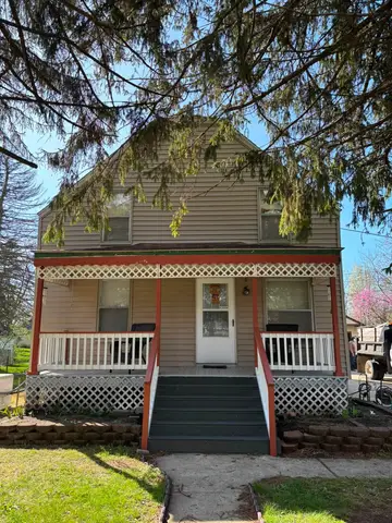 Front view of a two-story house with porch in Metro Detroit