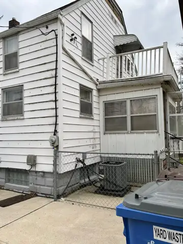 Side view of a house showing exterior details and utilities