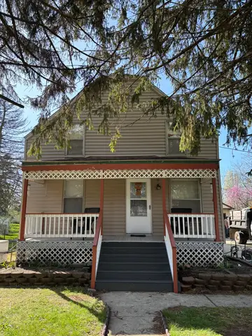 Front view of a two-story home with new siding and porch