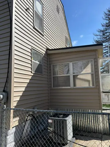 Close-up of a house's side with new siding and windows